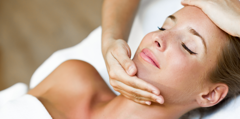 young-woman-receiving-head-massage-spa-center 1.png